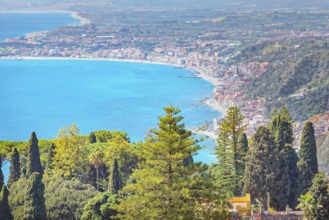 View of the Ionian coast and Giardini di Naxos in the distance, Taormina, Sicily, Italy, Europe