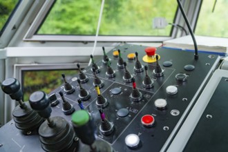 Control panel in bright surroundings, several levers and buttons in different colours, Hermann