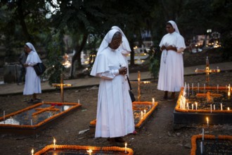 Nuns offer prayers on the grave during the All souls day observation, in Guwahati, India on 2