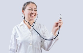 Smiling female doctor hand holding stethoscope isolated. Young female doctor holding stethoscope on