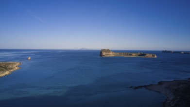 Drone shot, Remote island with wide view of the clear blue ocean and bright sky, Venetian Sea