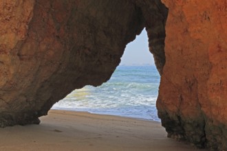 Praia do Pinhao, Lagos, Algarve, Portugal, A natural rock arch on the beach overlooking the sea and