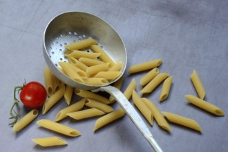 Pasta, Italian penne in a sieve ladle