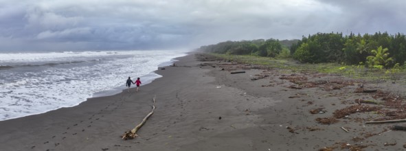 Two tourists on the beach, coast with rainforest, Tortuguero National Park, Costa Rica, Central