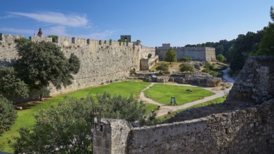 Grand Master's Palace, view of a medieval castle with courtyard and green lawn, surrounded by