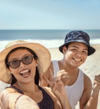 Two happy friends taking a selfie on the beach. Selfie of two happy friends on the beach vacations