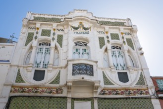 Historic Art Nouveau façade of a villa with green and white decorations and ornate windows, Villa