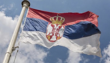 Flags, the national flag of Serbia flutters in the wind