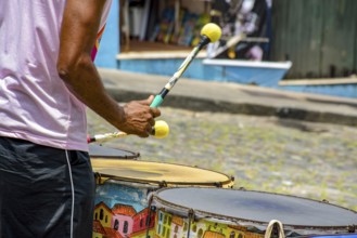 Drummer with colorful drums on the slopes of Pelourinho in the city of Salvador, Bahia, Pelourinho,