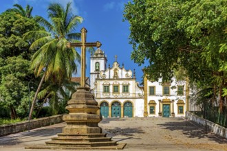 Square with historic baroque church and stone crucifix in Olinda, Pernambuco, Brazil, South America