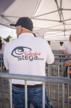 Security guard leaning against a barrier, background tent, Malleparty Böblingen, Germany, Europe