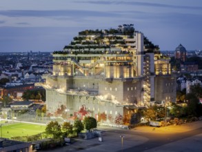 Aerial view of the Hamburg Bunker with green terraces and modern architecture in the evening