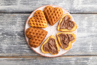 Homemade waffle with chocolate butter on a gray wooden background. top view, flat lay, close up