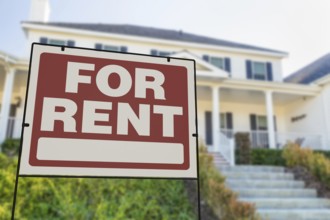 For rent real estate yard sign in front of house.