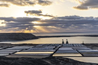 Salt fields under a dramatic sunset with clouds, Canary Islands, Lanzarote, Spain, Europe