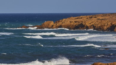 Rippled sea surface along a rocky coastline under a clear sky, west coast, Karpathos, Dodecanese,