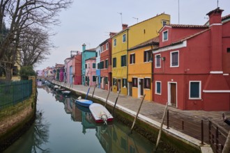 Colorful houses beside the waterway at 'Fondamenta di Terranova' with boats lying in the water on