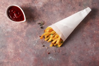 Fried French fries, in a paper bag, on an abstract background, no people, rustic