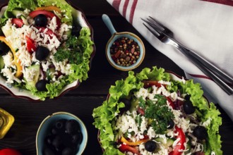 Traditional Bulgarian dish, Shopska salad, on a wooden table, salad of fresh vegetables, top view,