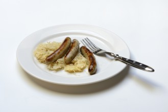 Nuremberg sausages with sauerkraut on a plate, Rostbratwurst, Germany, Europe