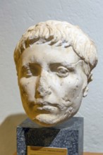 Roman carved stone head portrait of young man, archaeology museum, Apollonia Archaeological Park,