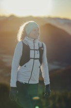 Trail running in autumn on the Jochberg on Lake Walchensee against the wonderful backdrop of the