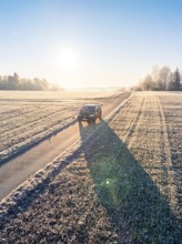 An SUV drives along a frosty country lane in bright sunshine, Car Sharing, electric car, Volkswagen