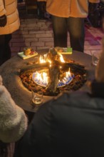 People gather around an outdoor campfire, it's warm and cosy, Night of Lights, Nagold, Black