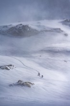 Dramatic atmosphere, Ski tourers in the vast landscape, Snow-covered mountain landscape, Bernese