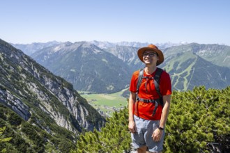 Mountaineer on a hiking trail between mountain pines, mountaineer climbing the Hochunnütz, Unnütz