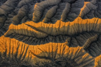 Landscape of eroded hills, badlands at sunset, top down shot, aerial view, Canyon of the Forgotten