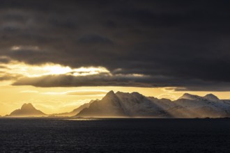 Light mood over steep mountains, coast, view of Vestvagoya, Lofoten, Norway, Europe