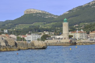 Bay with lighthouse and rock Couronne de Charlemagne, Crown of Charlemagne, Mediterranean coast,