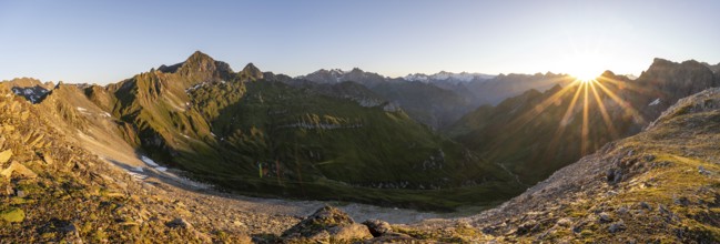 Mountain landscape at sunrise with sun star, view of mountain peaks of the Venediger group and into