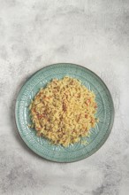 Basmati rice with saffron, on a decorative blue plate, light background, homemade, no people