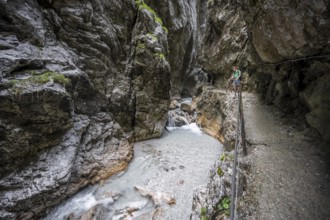 Hammersbach mountain stream in a canyon, mountaineer on a hiking trail in a gorge, Höllentalklamm,