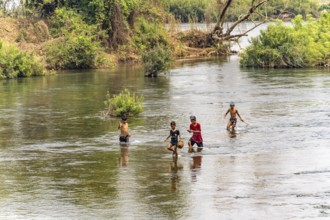 Children fishing in the Mekong near Don Det Island, Si Phan Don, Champasak Province, Laos, Asia