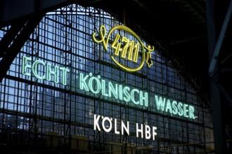 Illuminated advert for 4711, Echt Kölnisch Wasser at Cologne Central Station in the evening,