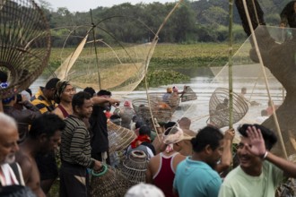 Villagers participate in a community fishing event on the occasion of the Bhogali Bihu festival at