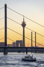 Sunset on the Rhine near Düsseldorf, skyline of the city centre with Rhine Tower, Rheinkniebrücke,