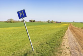 Meeting point road sign at a dirt road in the countryside a sunny day at springtime, Sweden, Europe