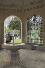 Interior view of the pavilion with Kochbrunnen at Kochbrunnenplatz, metal grid, persons, two,