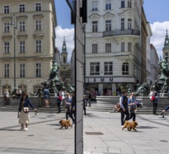 Pedestrians reflected in a shop window, Kärntner Straße at Donnerbrunnen, Vienna, Austria, Europe