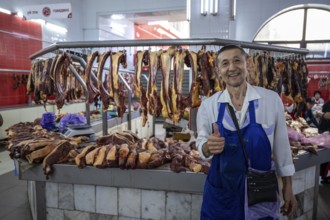 Butcher happy, fresh meat, market at Osh bazaar, Bishkek, Kyrgyzstan, Asia