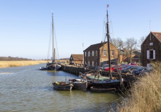 Historic boats and sailing barges at quayside, River Alde, Snape Maltings, Suffolk, England, UK