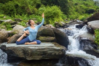 Hatha yoga outdoors, young sporty fit woman doing yoga asana Eka pada rajakapotasana, one-legged