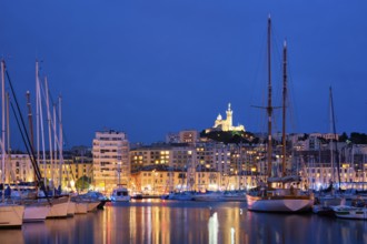 Marseille Old Port (Vieux-Port de Marseille) with yachts and Basilica of Notre-Dame de la Garde in