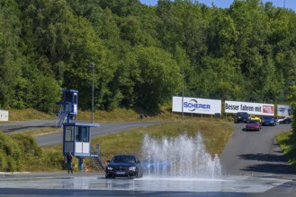 BMW M2 sports car retains control dodges obstacle in the form of water fountains on slippery