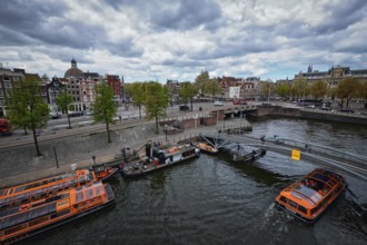 AMSTERDAM, NETHERLANDS, MAY 9, 2017: Aerial view of Amsterdam canal with tourist boats near