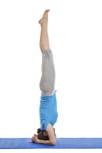 Yoga, young beautiful woman yoga instructor doing headstand (sirsasana) asana exercise isolated on